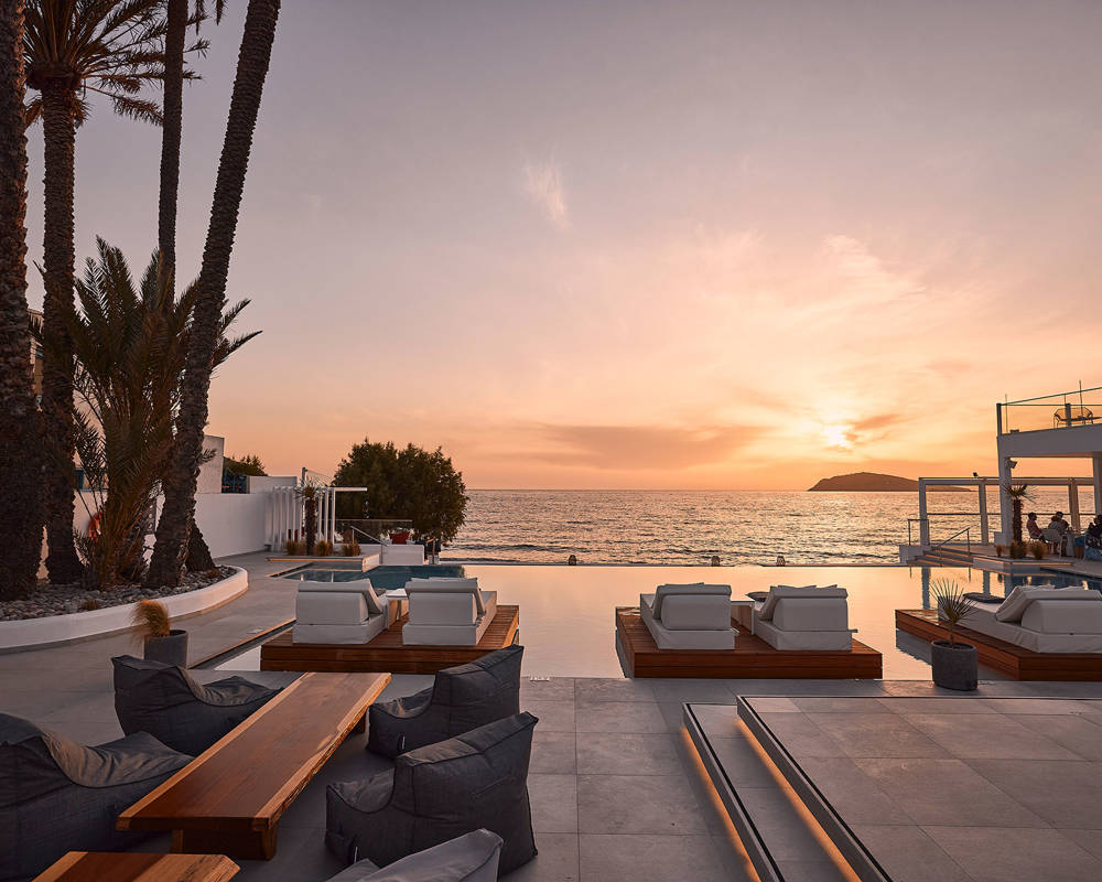 Sunset view of the pool and sunbeds