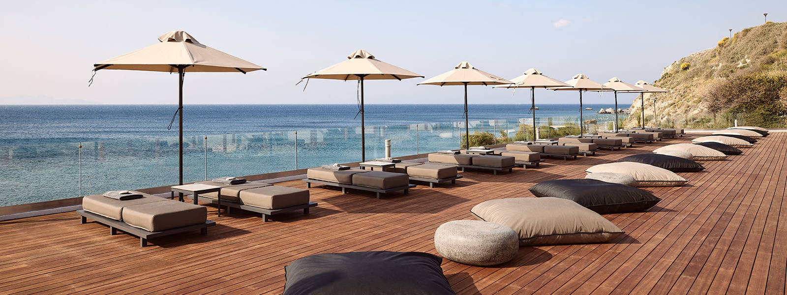 Sunbeds and umbrellas and the sea as background