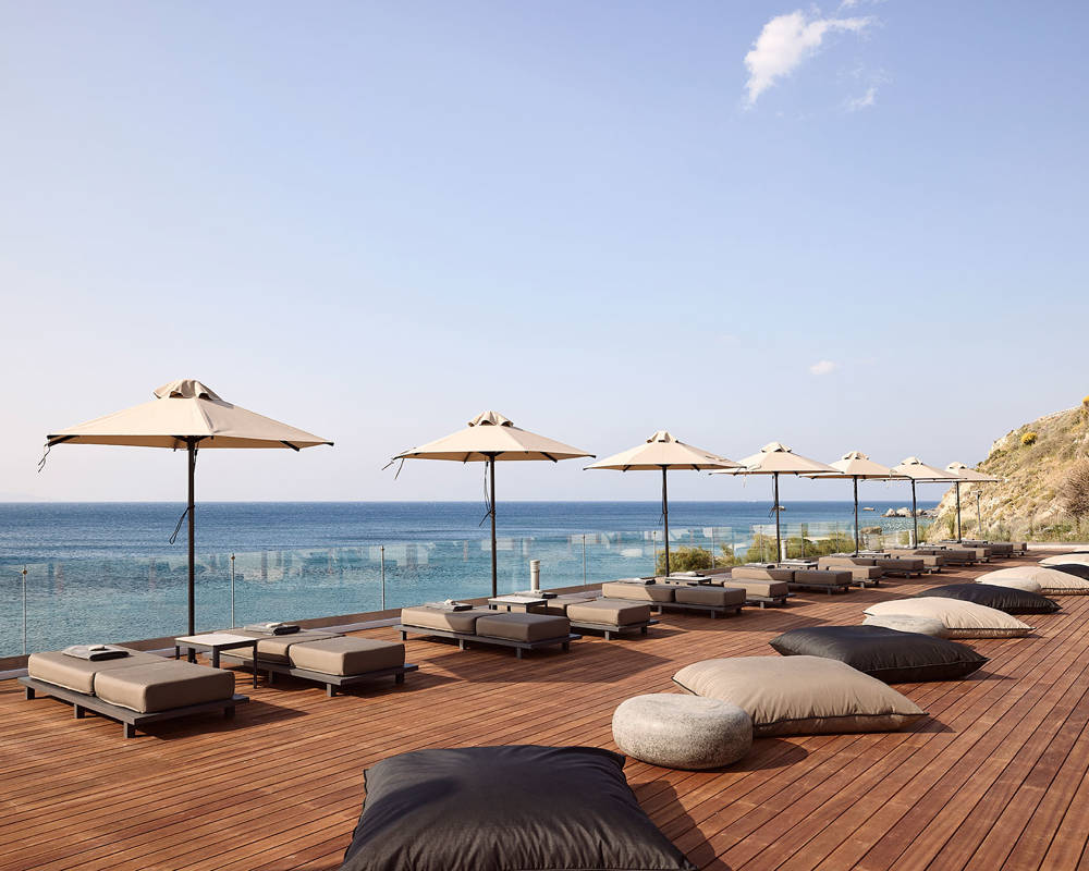 Sunbeds and umbrellas and the sea as background