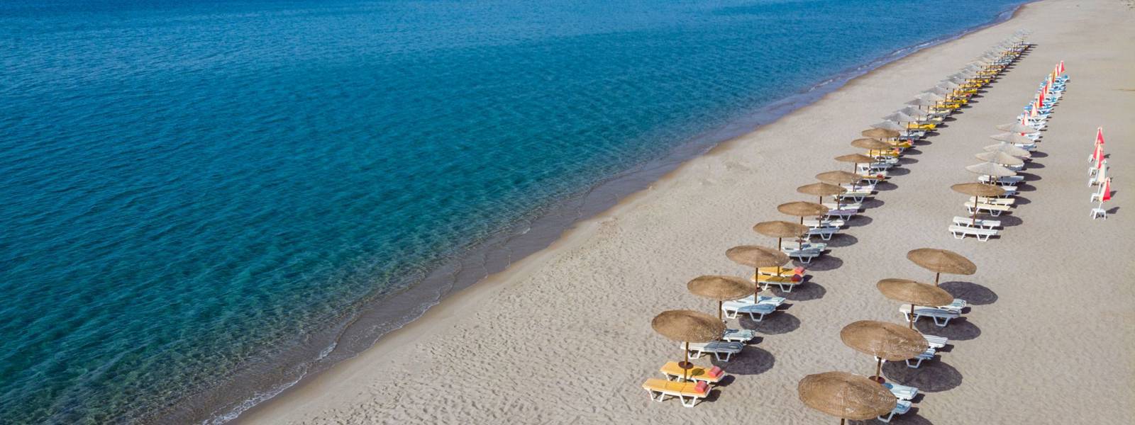 View of the beach with sunbeds and umbrellas from above