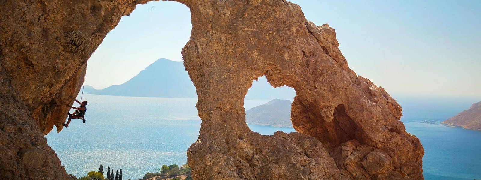 Rock climber with the sea as background
