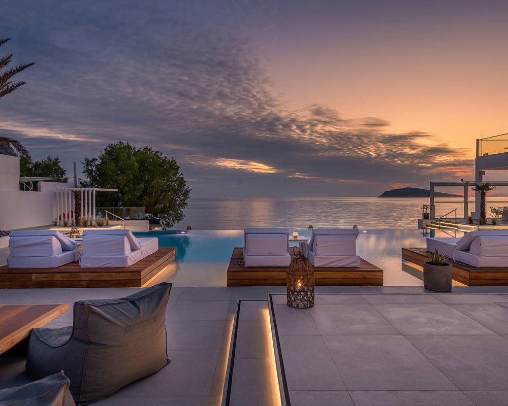 Sunset view of the pool and sunbeds