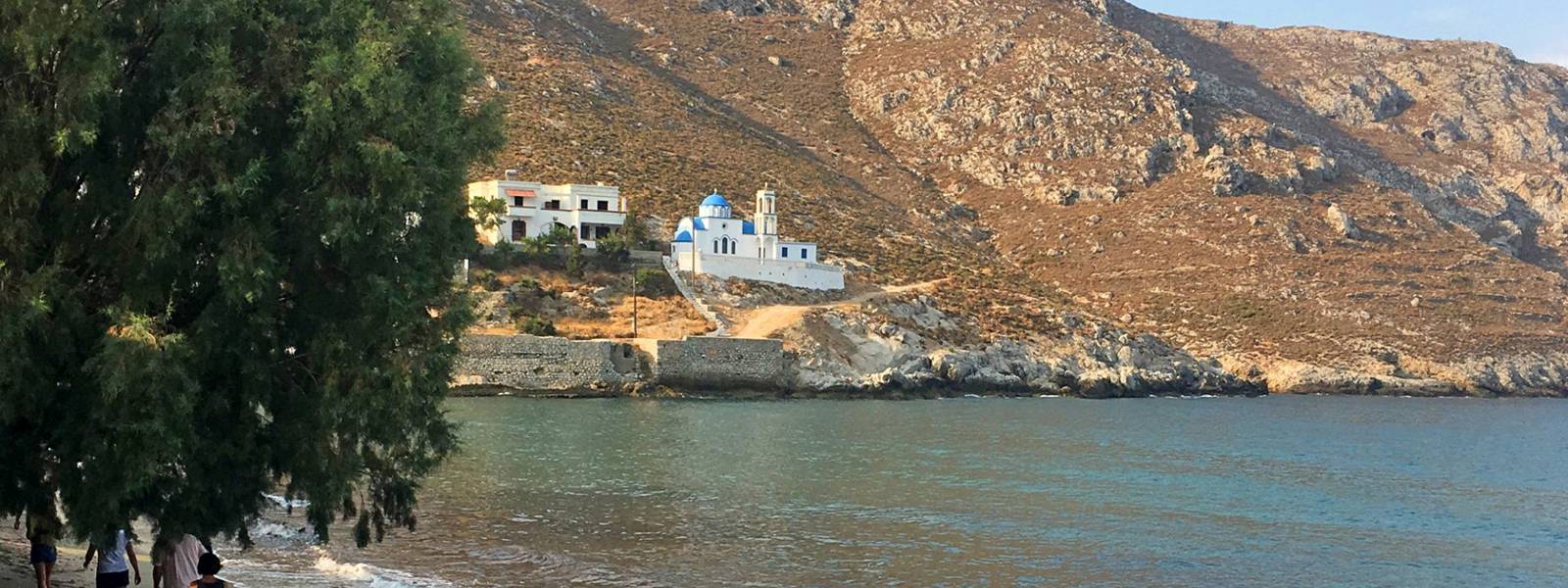 Beach side view of a mountain with a church