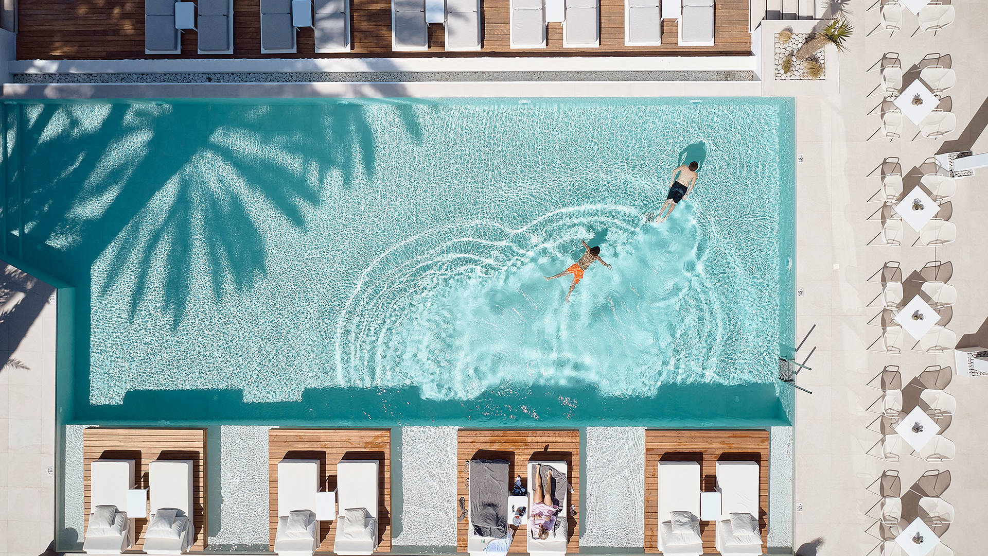 Top-down view of the pool and sunbeds